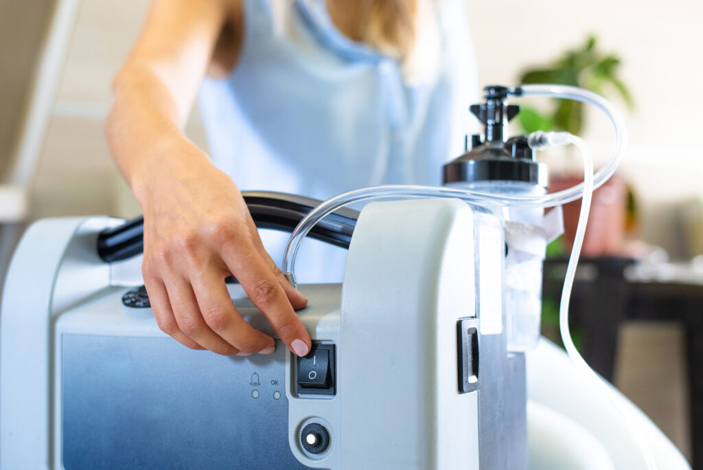 A person using a portable oxygen machine.